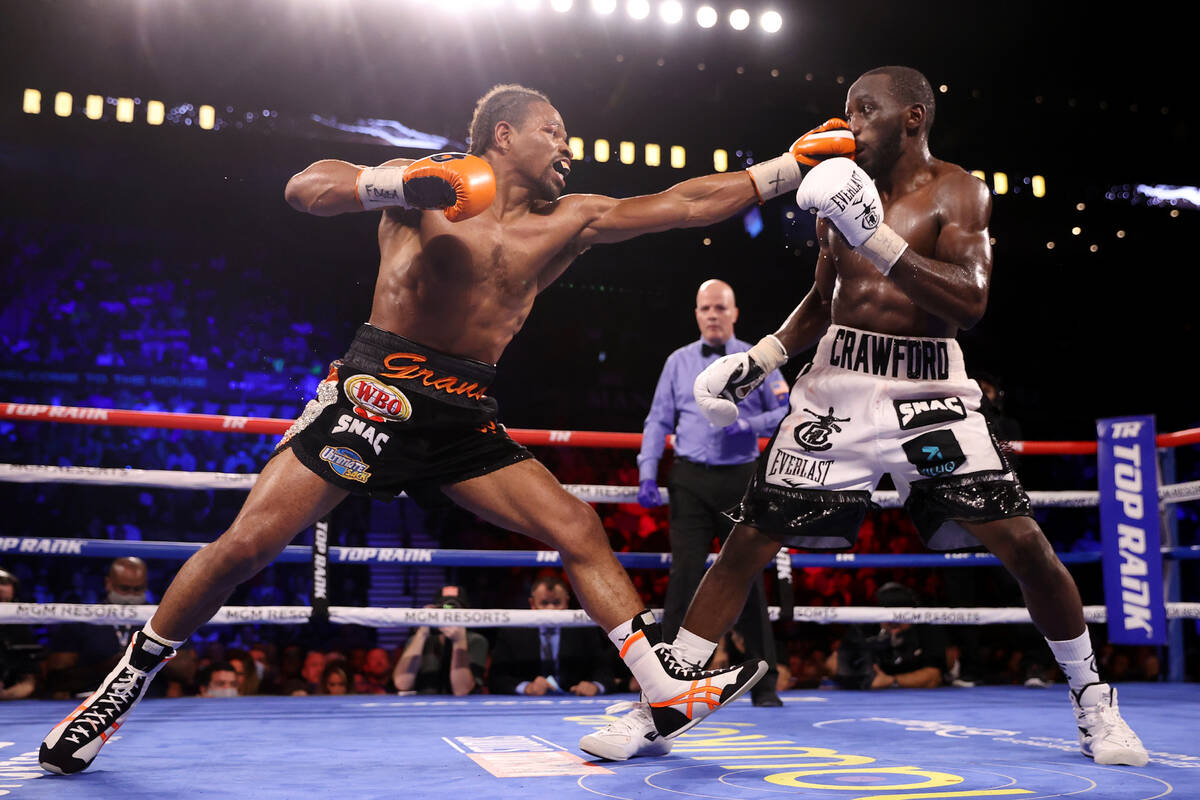 Shawn Porter, left, connects a punch against Terence Crawford in the ninth round of the WBO wel ...