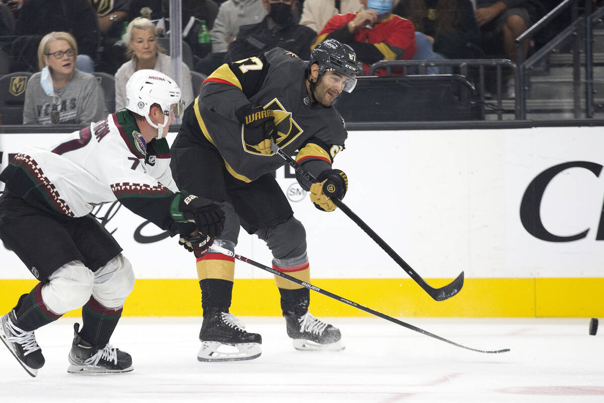 Golden Knights left wing Max Pacioretty (67) makes a shot on goal as Coyotes defenseman Victor ...