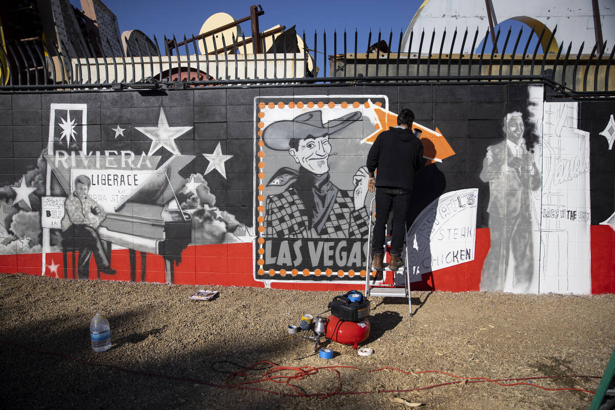 Ali Fathollahi works on a mural outside of the Neon Museum North Gallery in Las Vegas, Tuesday, ...