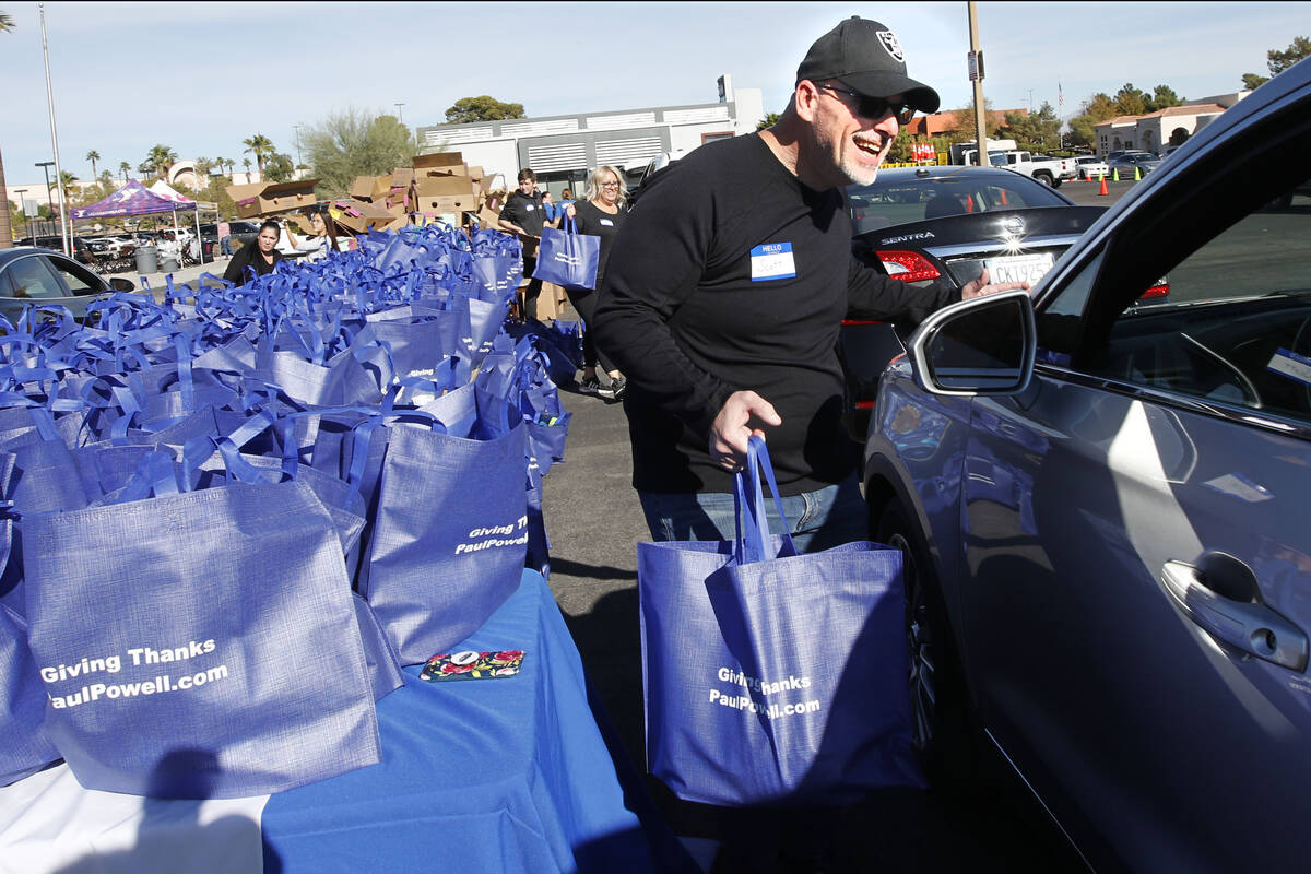 Dana Marcolongo of Paul Powell law firm helps to give away turkeys during Paul Powell's annual ...