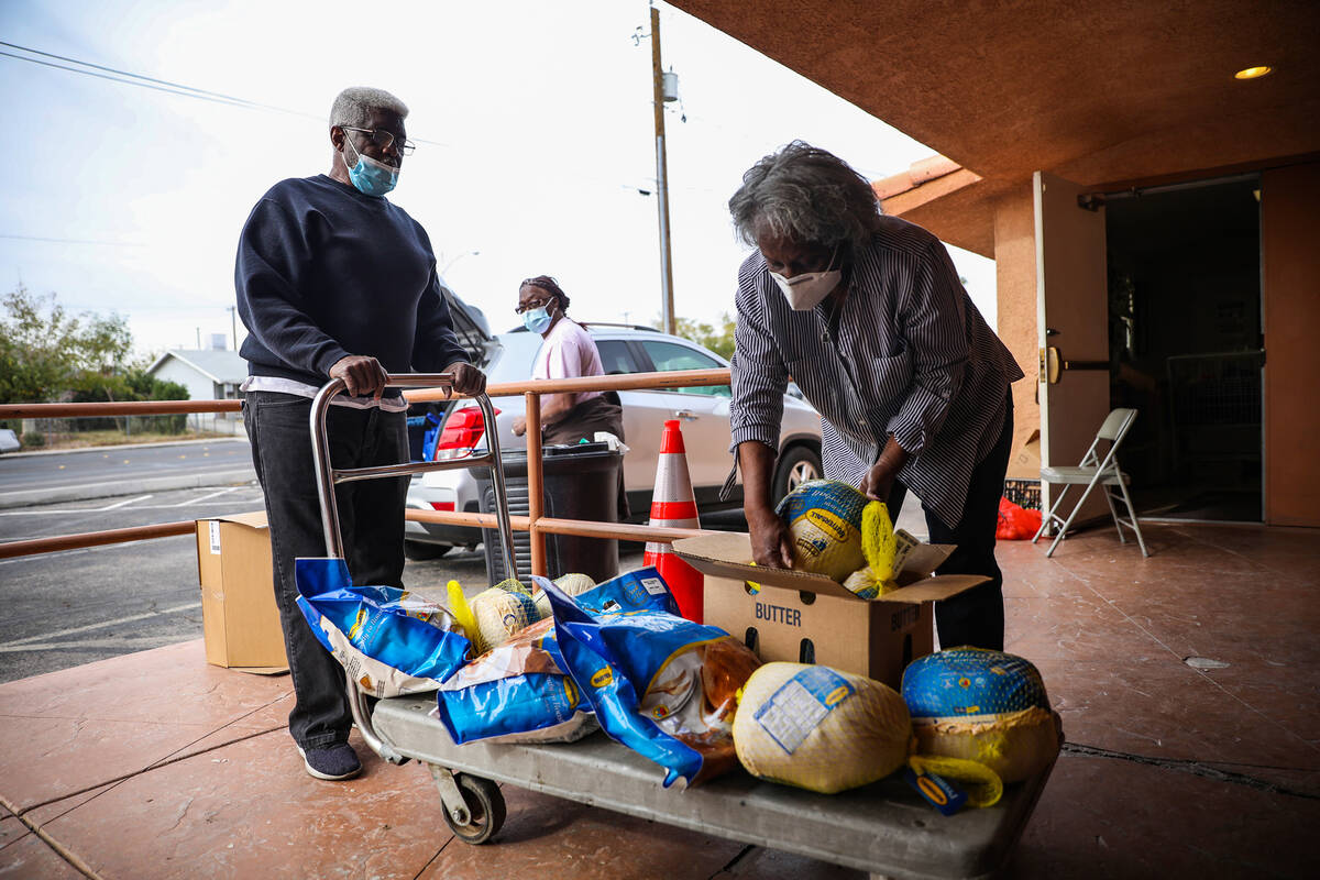 Volunteers Deacon Will Parks, left, gets help from his wife Mattie Parks, right, loading up a c ...
