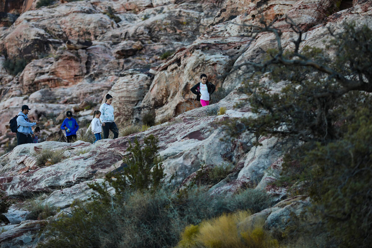 Hikers walk a trail in Calico Basin on the eastern edge of the Red Rock Canyon National Conserv ...