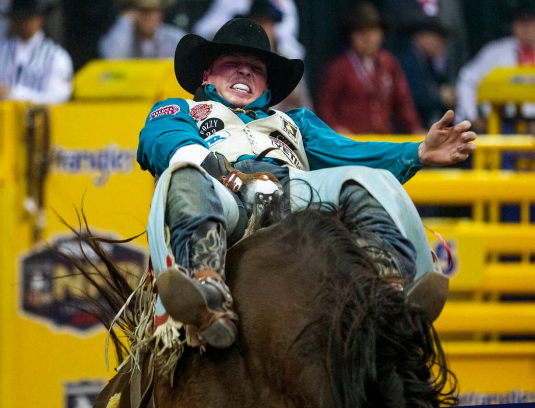 Richmond Champion of The Woodlands, Texas, digs deep in Bareback Riding during the tenth go ro ...