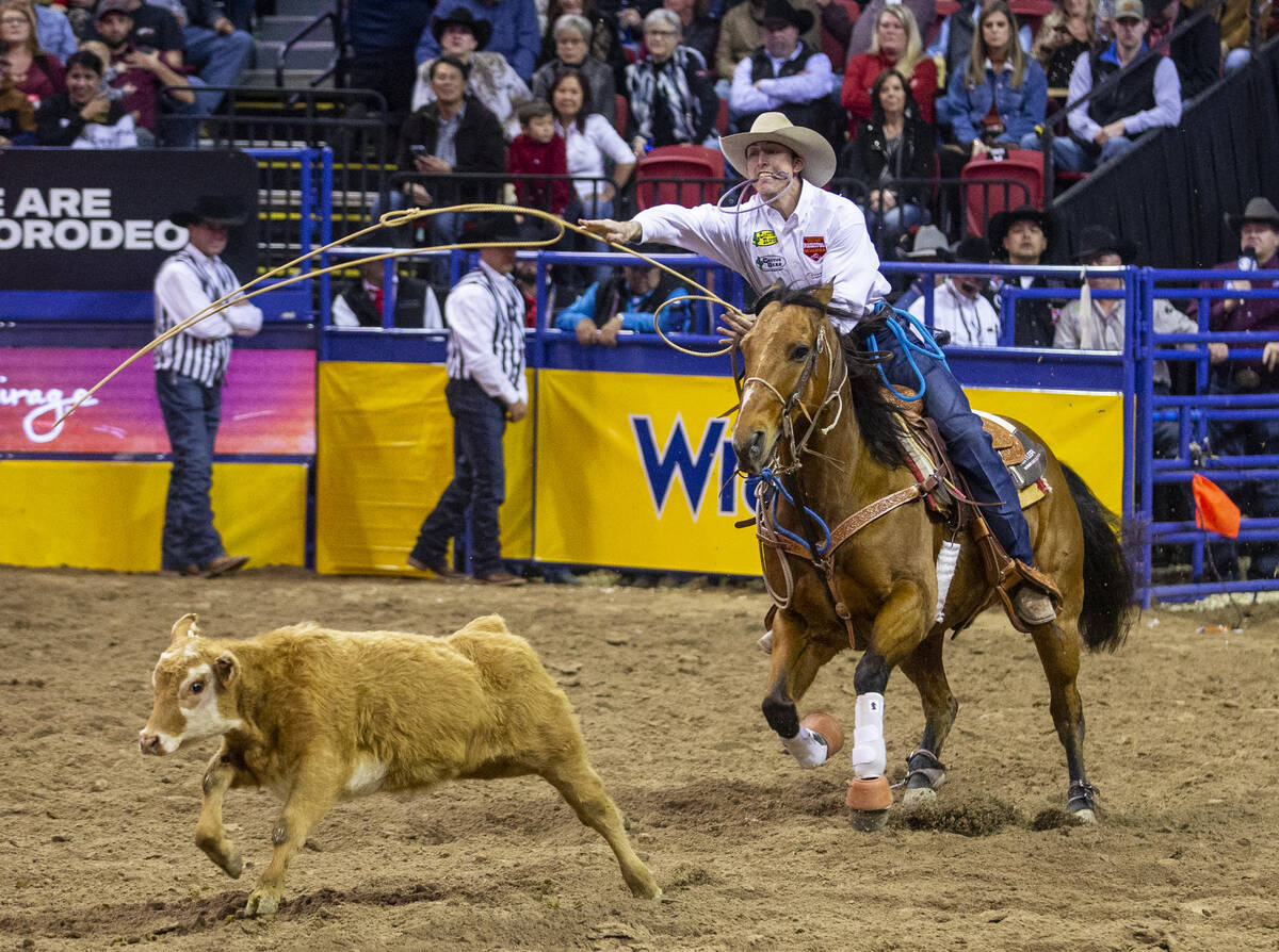 Taylor Santos of Creston, Calif., tosses his lasso in Tie-Down Roping at the tenth go round of ...