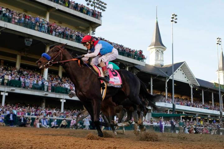 John Velazquez rides Medina Spirit across the finish line to win the 147th running of the Kentu ...