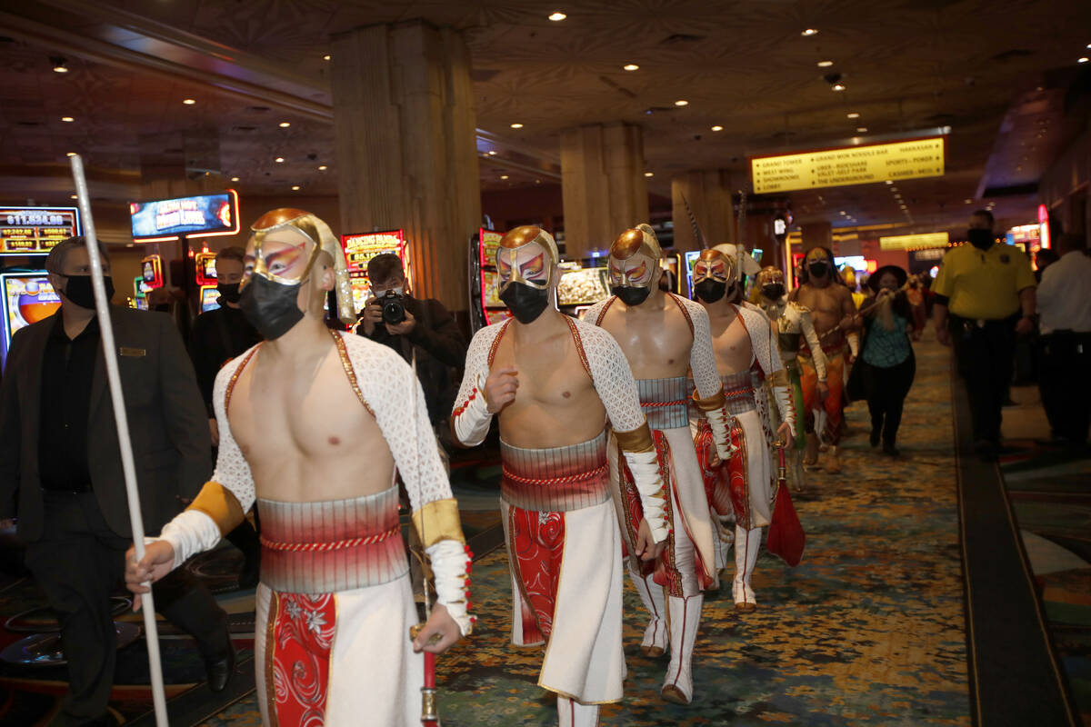 Cirque Du Soleil's KÀ artists walk to the theater after a pop-up performance in the lobby of M ...
