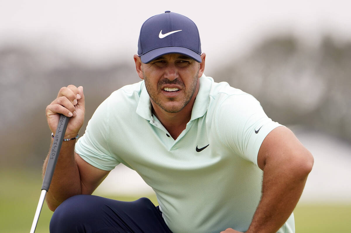 In this June 19, 2021, file photo, Brooks Koepka studies the second green during the third roun ...