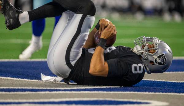 Raiders quarterback Marcus Mariota (8) leaps into the end zone past Dallas Cowboys free safety ...
