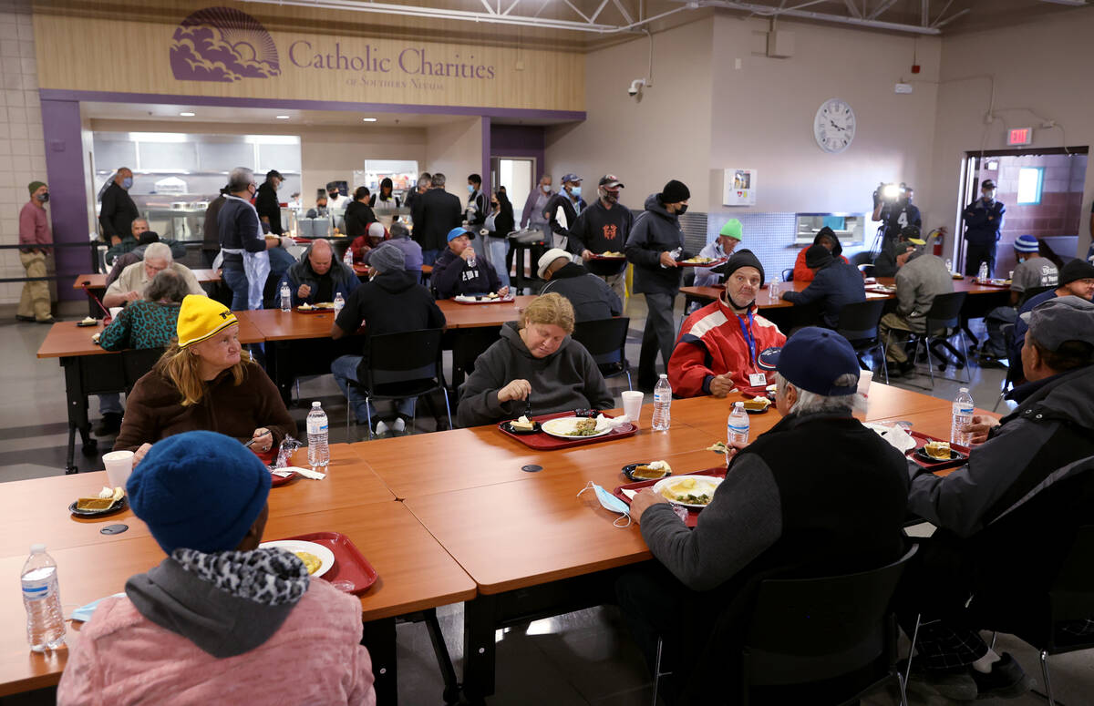 Guests eat a free Thanksgiving meal in the renovated St. Vincent Lied Dining Facility at Cathol ...