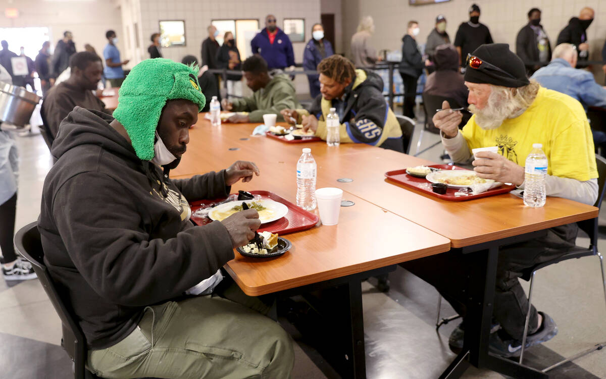 Marcus Denmond, 50, left, and Harry Barr, 57, eat a free Thanksgiving meal in the renovated St. ...