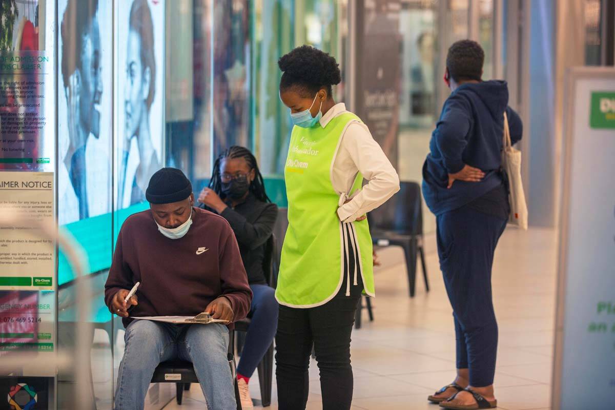 People wait to get vaccinated at a shopping mall, in Johannesburg, South Africa, Friday Nov. 26 ...