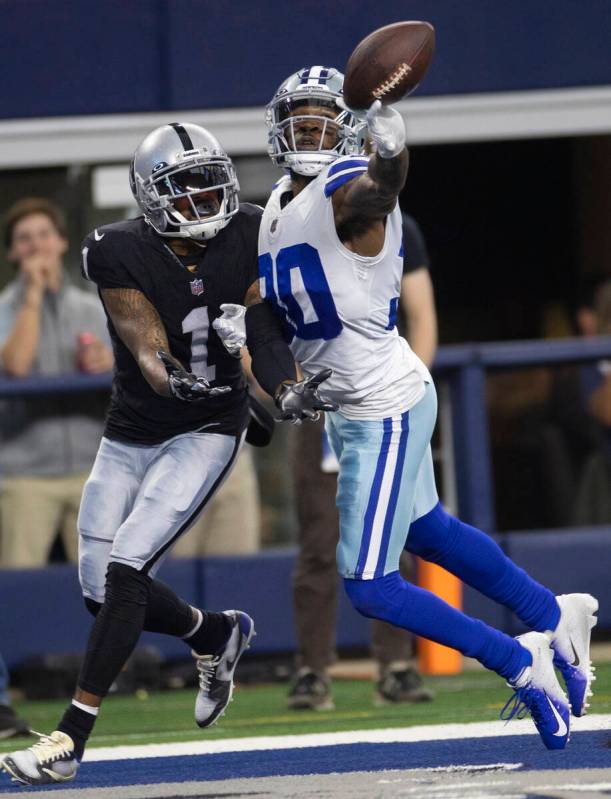 Dallas Cowboys cornerback Anthony Brown (30) attempts to break up a pass intended for Raiders w ...