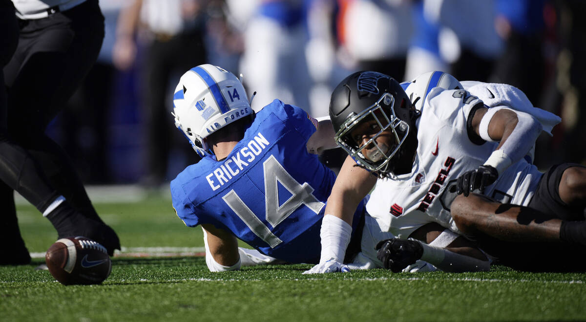 UNLV kick returner Nohl Williams, right, fumbles the football after being hit by Air Force spec ...