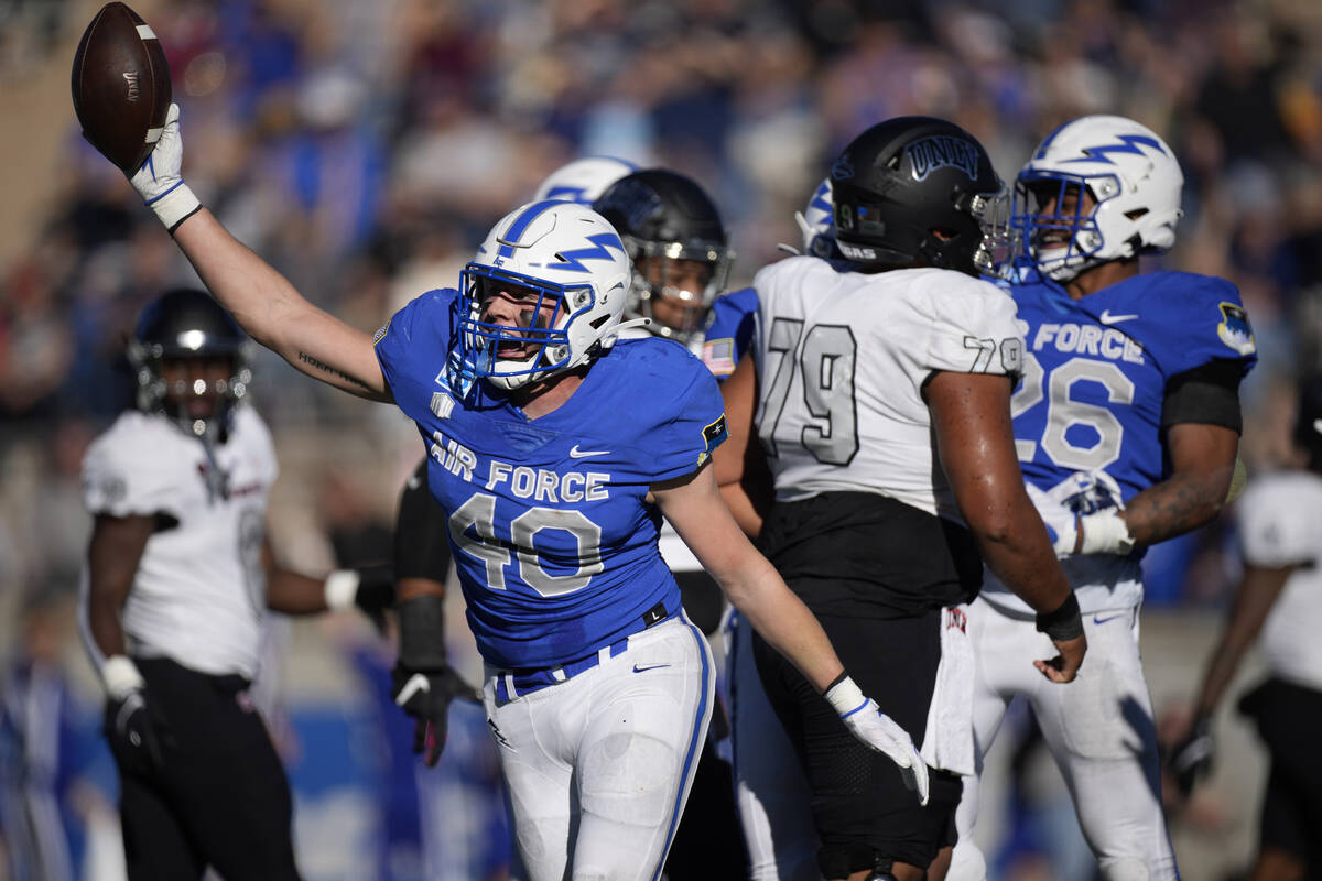 Air Force linebacker Alec Mock celebrates after recovering a fumble by UNLV quarterback Justin ...