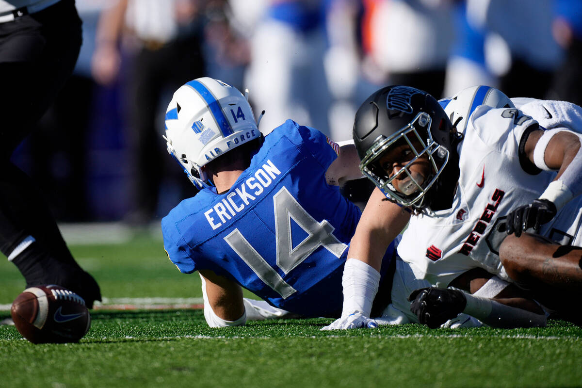 UNLV kick returner Nohl Williams, right, fumbles the football after being hit by Air Force spec ...