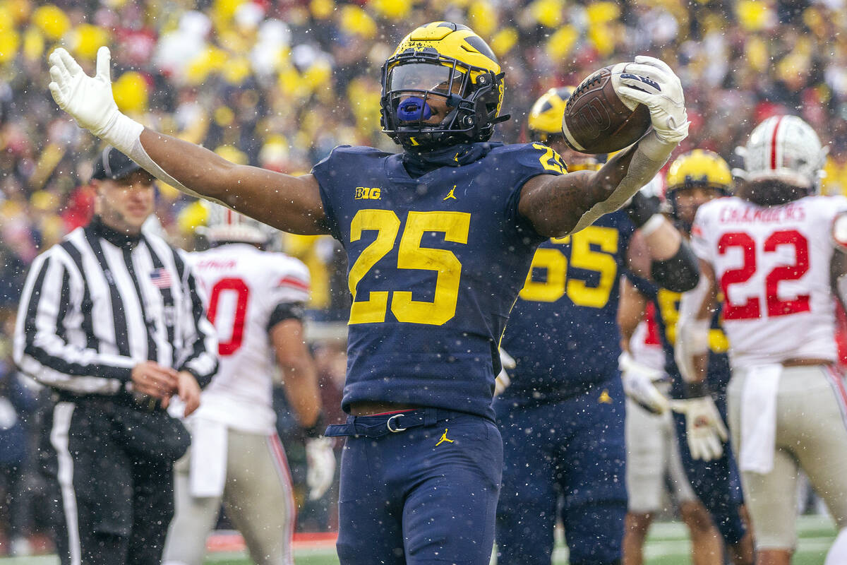 Michigan running back Hassan Haskins (25) celebrates a touchdown in the fourth quarter of an NC ...