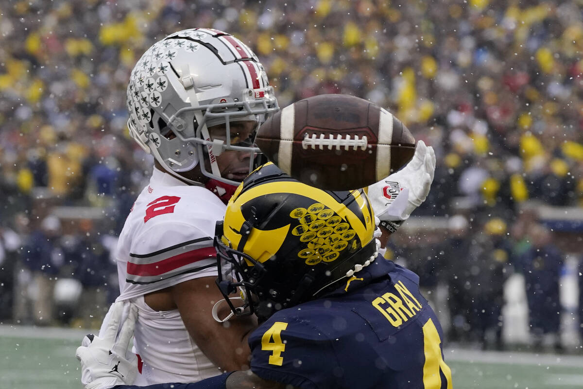 Michigan defensive back Vincent Gray (4) breaks up a pass intended for Ohio State wide receiver ...