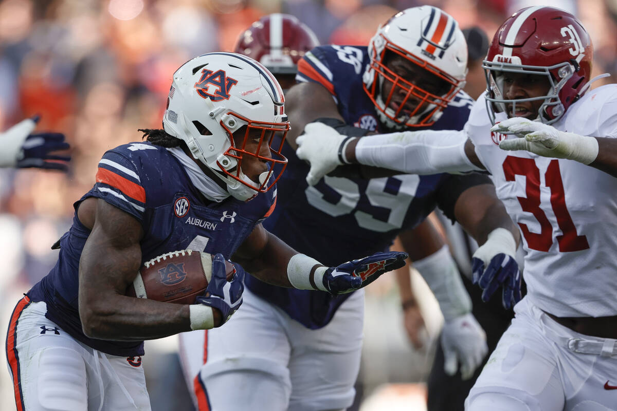 Auburn running back Tank Bigsby (4) carries the ball against Alabama during the first half of a ...