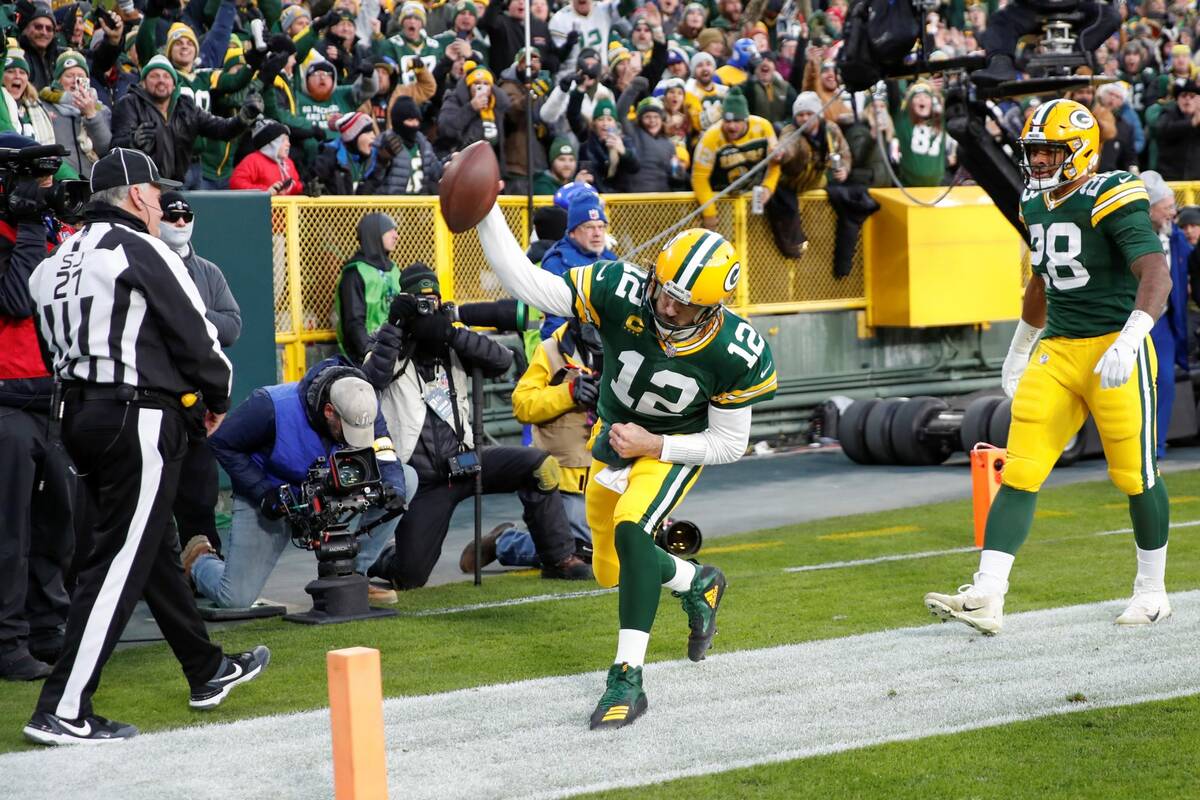 Green Bay Packers quarterback Aaron Rodgers (12) reacts after scoring a touchdown against the L ...