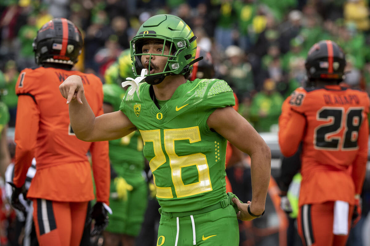 Oregon running back Travis Dye (26) celebrates a touchdown during the first quarter of an NCAA ...