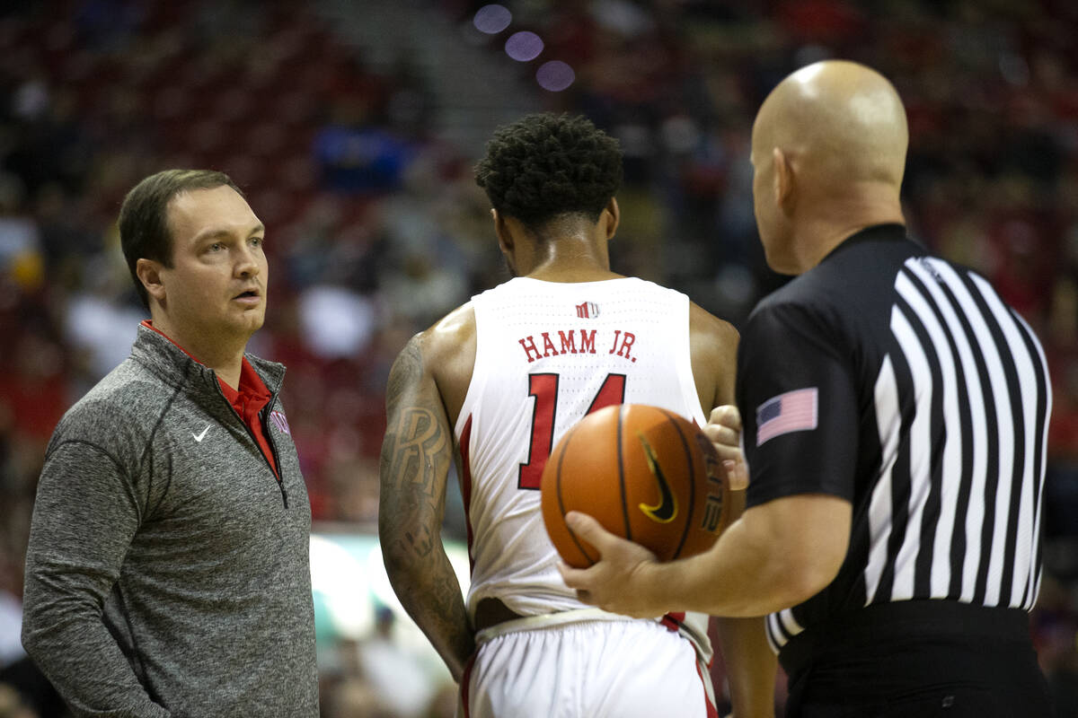 UNLV Rebels head coach Kevin Kruger communicates with a referee after he called a double foul o ...