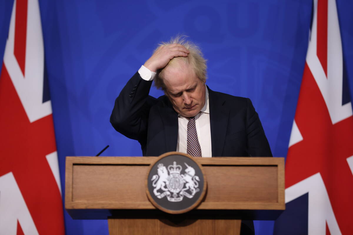 Britain's Prime Minister Boris Johnson gestures as he speaks during a press conference in Londo ...