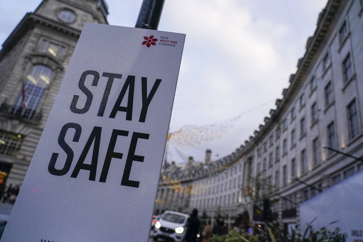 A sign reading 'Stay safe' in Regent Street, in London, Friday, Nov. 26, 2021. A slew of nation ...