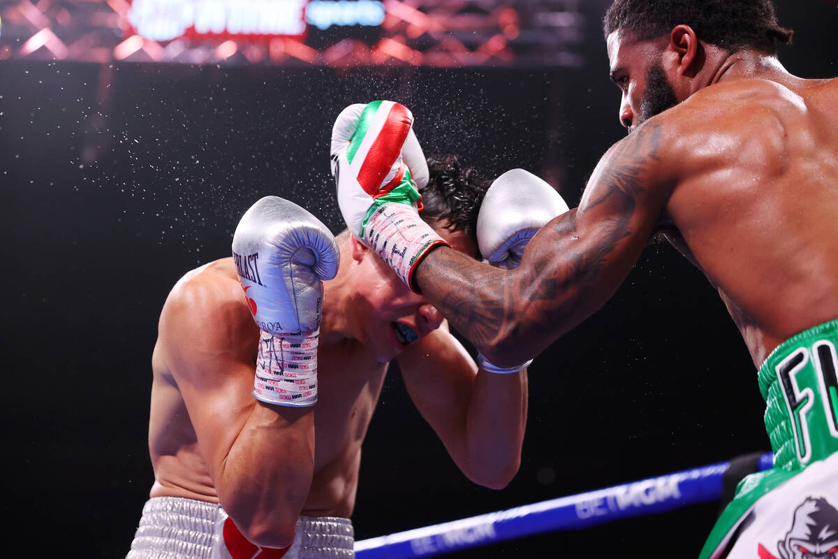 Stephen Fulton, right, connects a punch against Brandon Figueroa in the super bantamweight worl ...