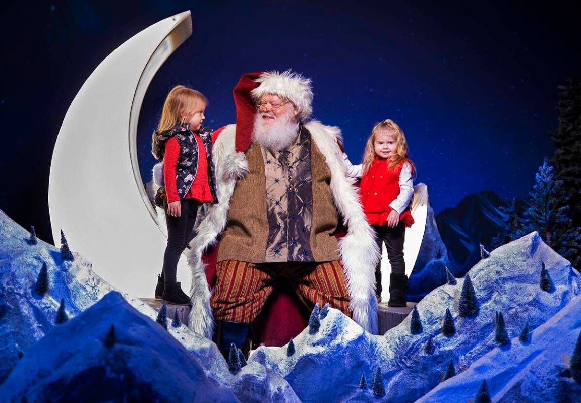 Kennedy, left, 3, and Mila Tucker, 2, talk with Santa at Enchant Christmas at Las Vegas Ballpar ...