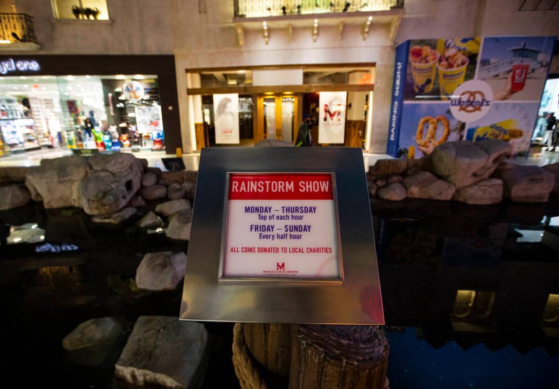A sign promoting coins to be tossed during the rainstorm show is seen at the Miracle Mile Shops ...