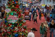 Shoppers make their way up a main aisle during the opening night of the Cowboy Channel Cowboy C ...