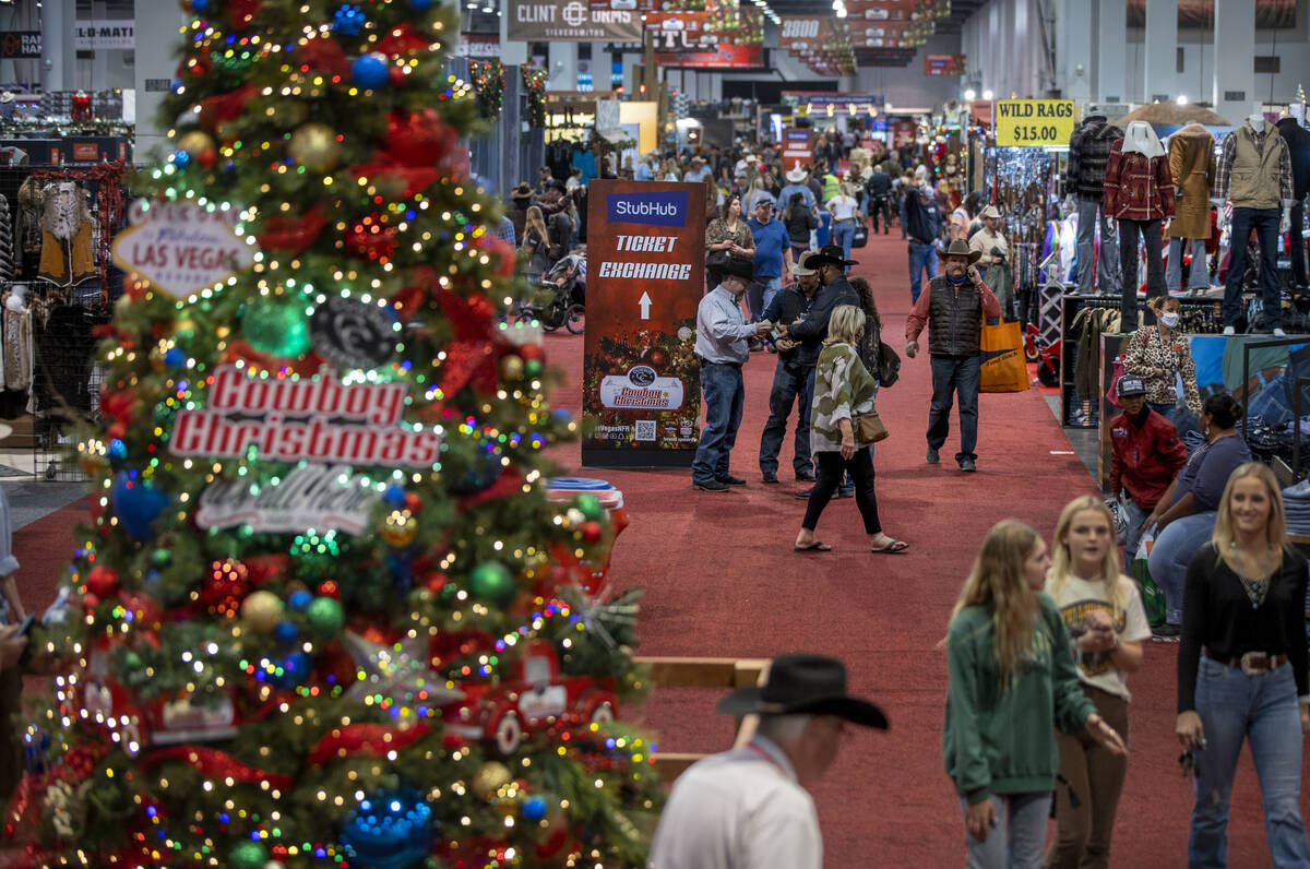 Shoppers make their way up a main aisle during the opening night of the Cowboy Channel Cowboy C ...