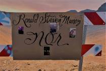 A cardboard sign in Summerlin marks the desert area where Ronald Munoz was found dead last mont ...