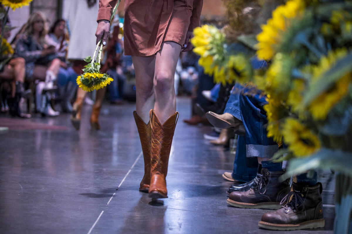 A model shows off new boots during the RockinÕ Rodeo Runway presented by Boot Barn during ...