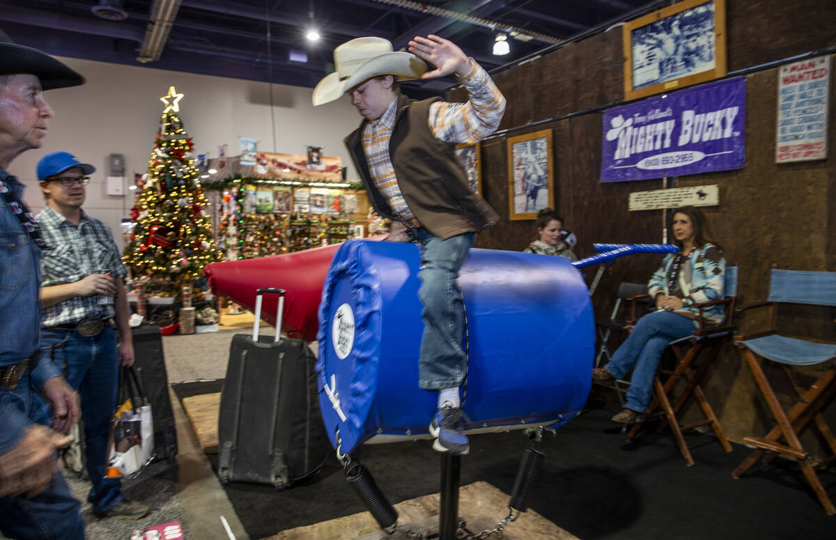 Ayden Lucas, 12, of Alberta tries out a Mighty Bucky under the direction of merchandise owner T ...