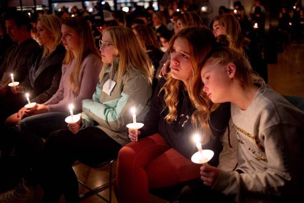 Emerson Miller, right, leans on her friend Joselyn's shoulder as they listen to Jessi Holt, pas ...