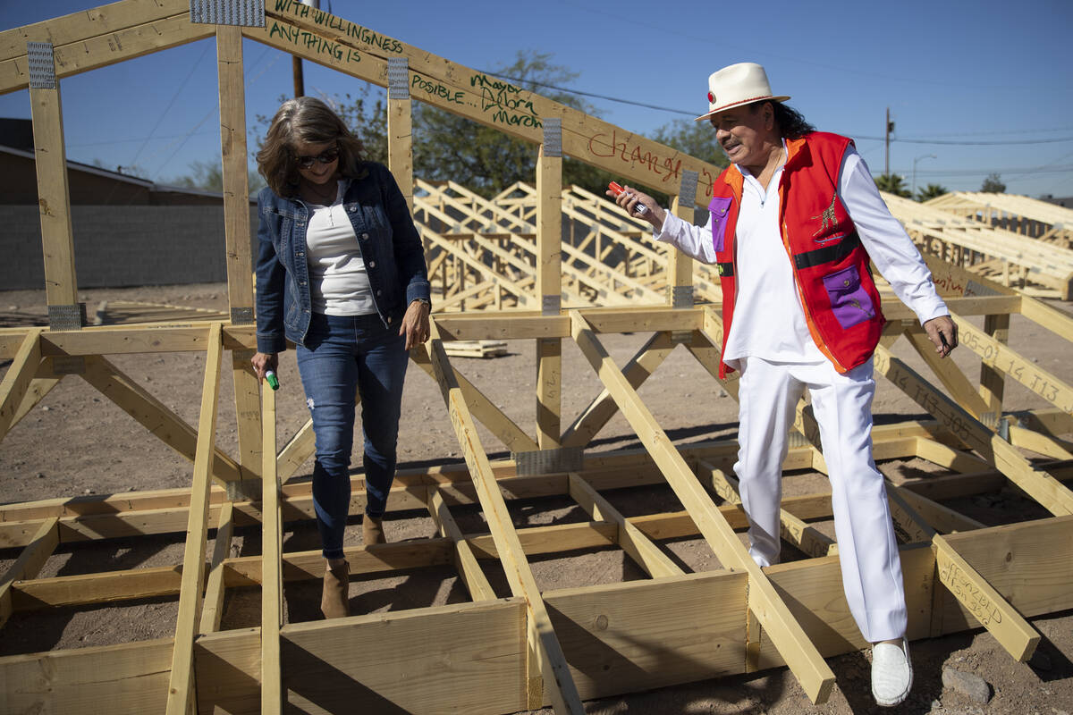 Henderson Mayor Debra March, left, and musician Carlos Santana speak at the site of future Habi ...