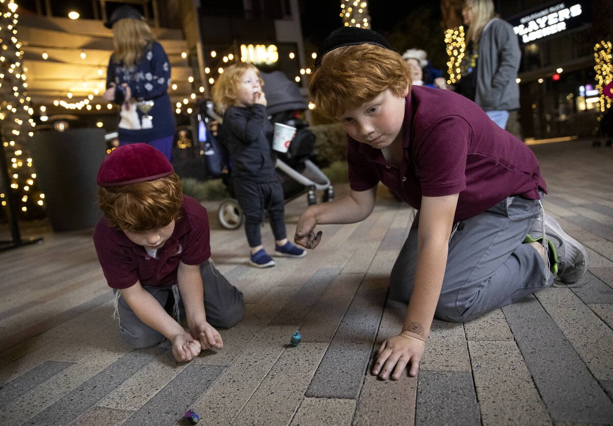Aiden Silver, 7, left, and his brother Ashton Silver, 10, spin dradels during the fourth night ...
