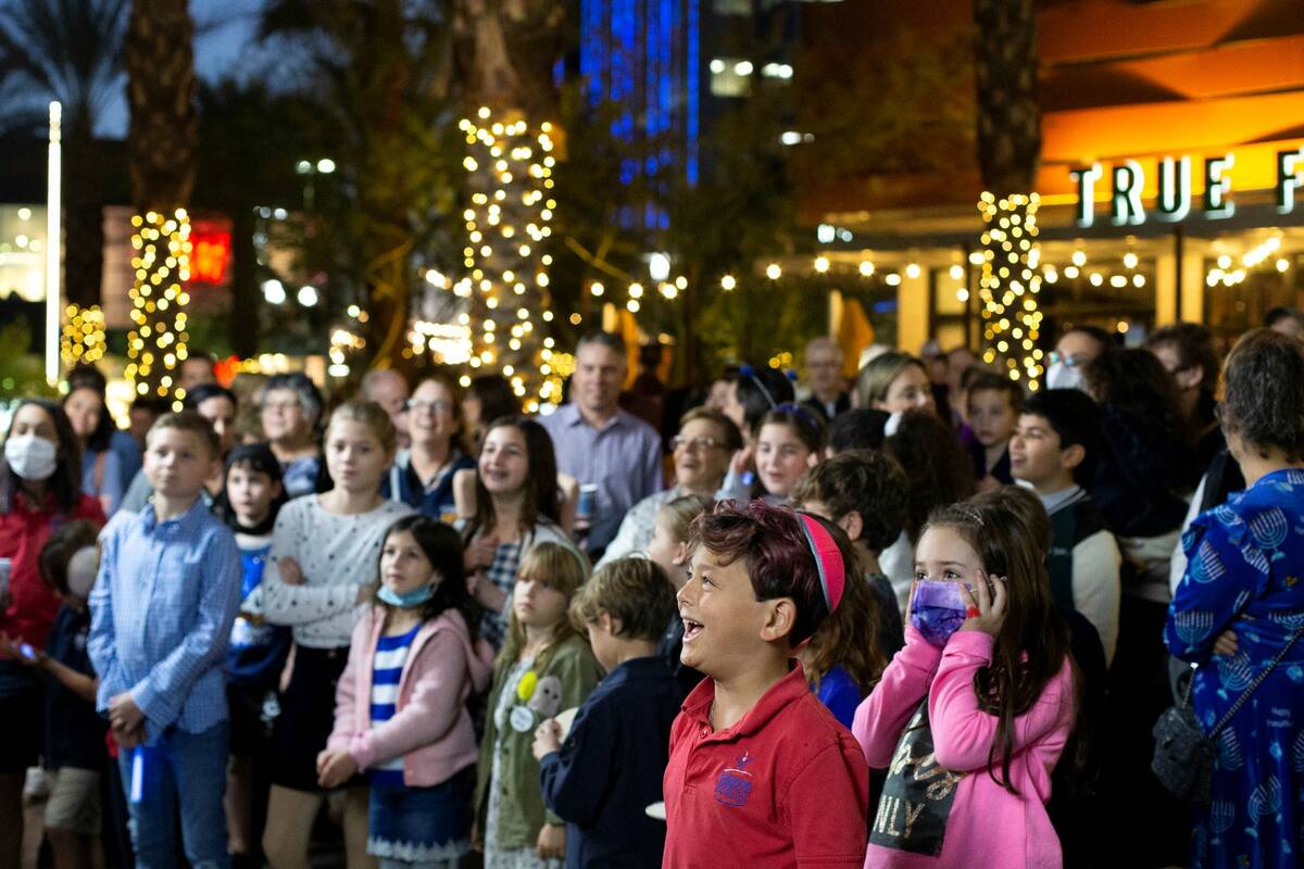 Community members attend the fourth night of Hanukkah celebration with Jewish Nevada at Downtow ...