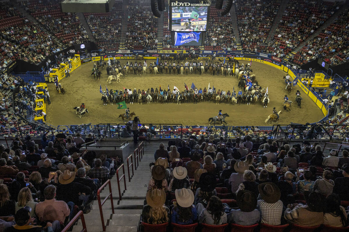 Competitors gather in the arena as the fans applaud at the start of the opening night of Wrangl ...