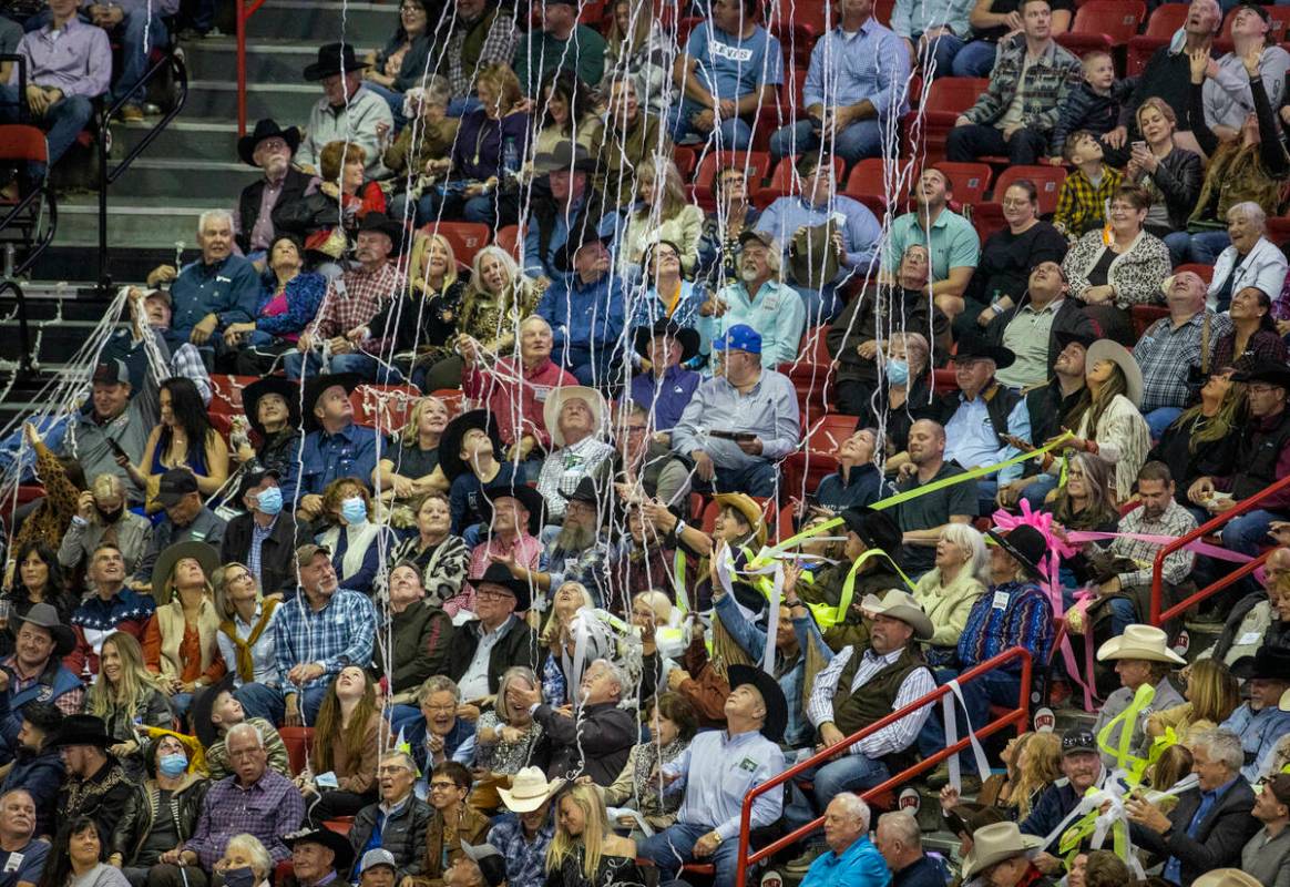 Fans are showered with confetti by the Blue Man Group during the opening night of Wrangler Nati ...