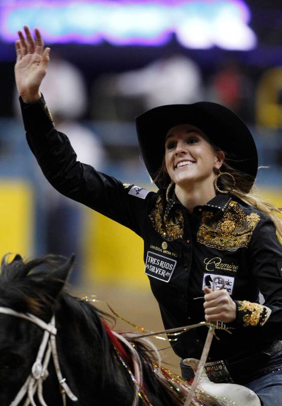 Taylor Jacob waves to the crowd after wining the third go-round in the barrel racing event on t ...