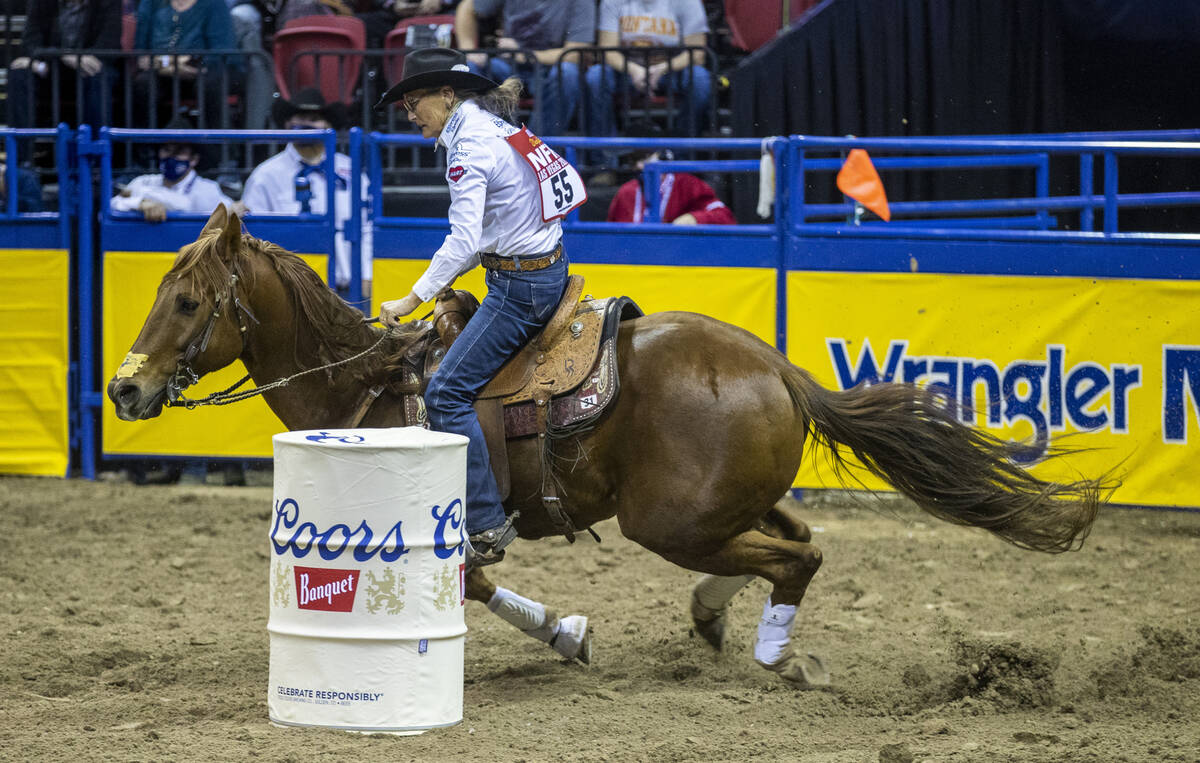 Dona Kay Rule of Minco, OK., turns a corner for home for first place in Barrel Racing during th ...