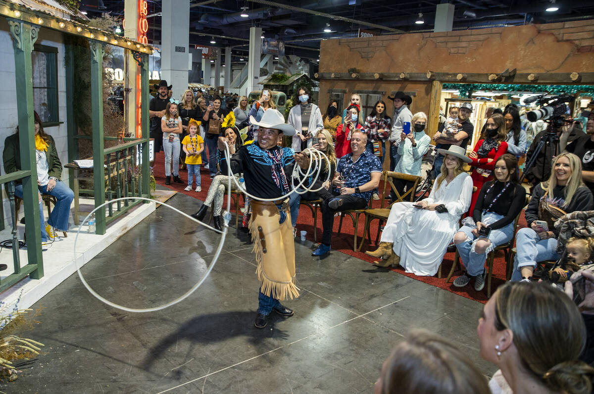 A trick roper model shows off his skills along with a western outfit and boots during the Rocki ...