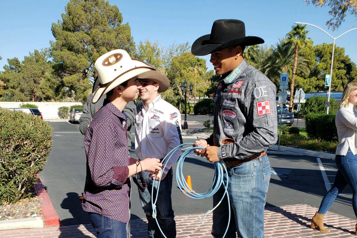 Shad Mayfield teaches Angelo Mayorga how to rope during Friday’s visit by Wrangler NFR contes ...