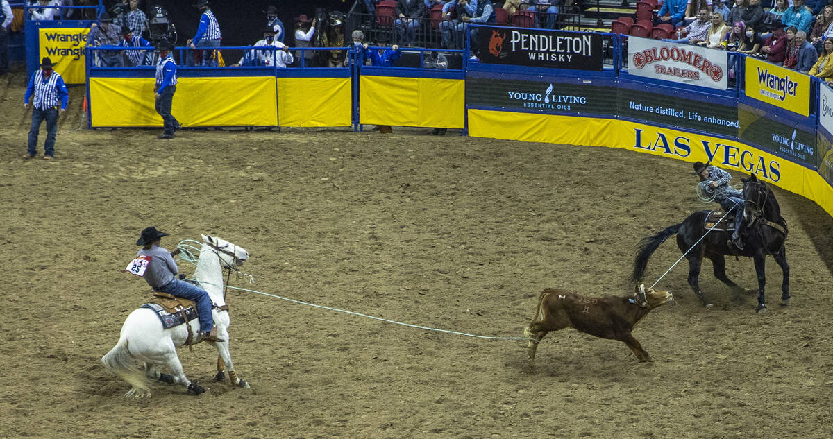 Clay Smith of Broken Bow, Oklahoma, and Jade Corkill of Fallon, Nevada, secure their animal in ...