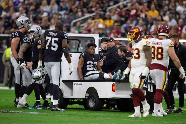 Raiders running back Kenyan Drake (23) is carted off the field during the second quarter of an ...