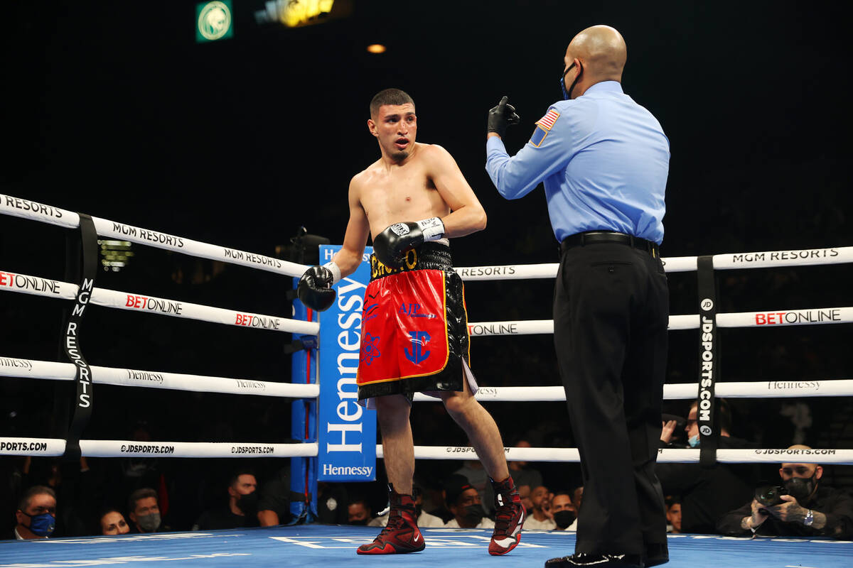 Carlos Diaz gets a count after getting knocked down by Montana Love in second round of a super ...