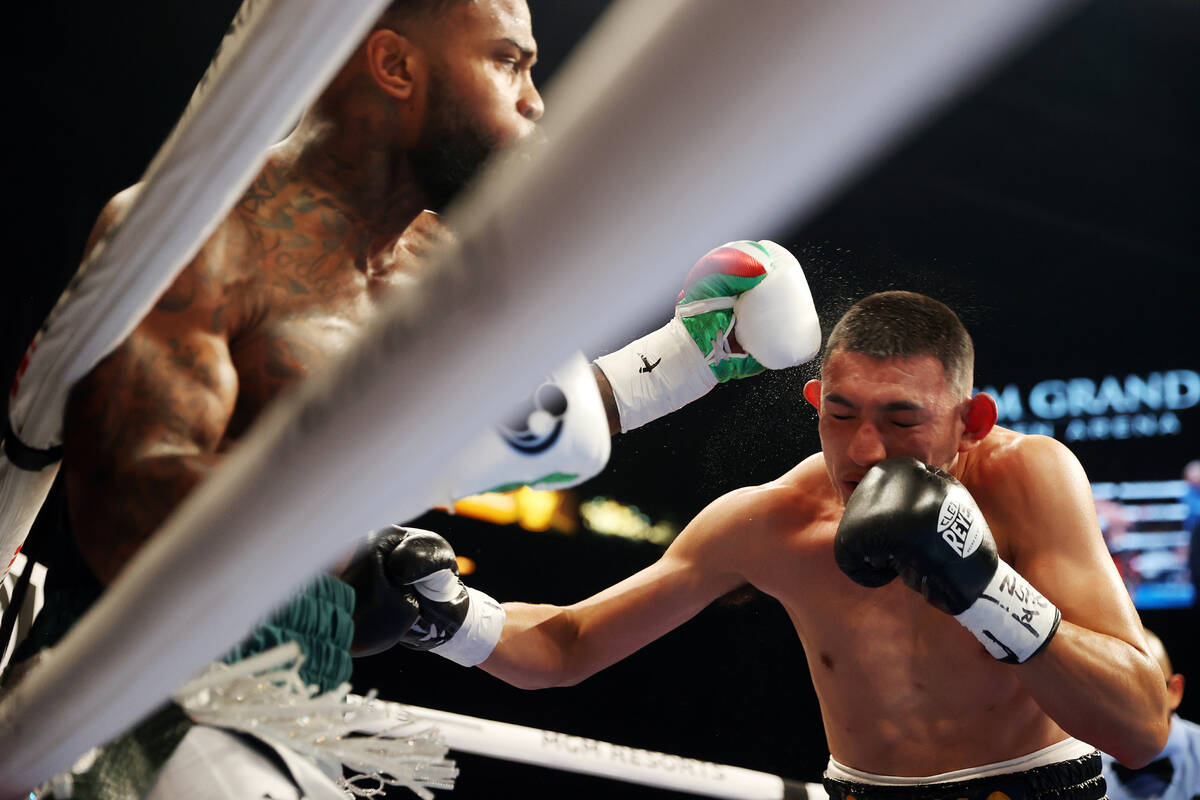 Montana Love, left, throws a punch to knock down Carlos Diaz in second round of a super lightwe ...