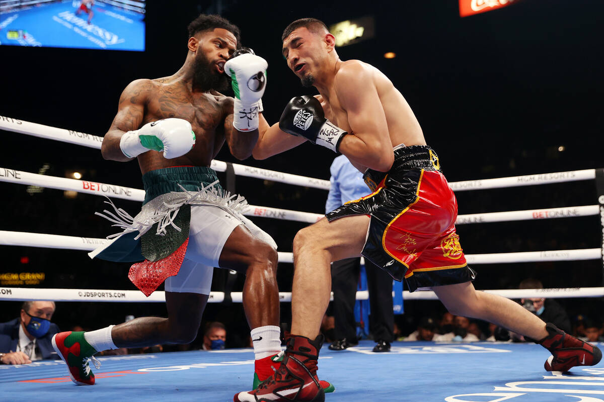 Montana Love, left, connects punch against Carlos Diaz in first round of a super lightweight bo ...